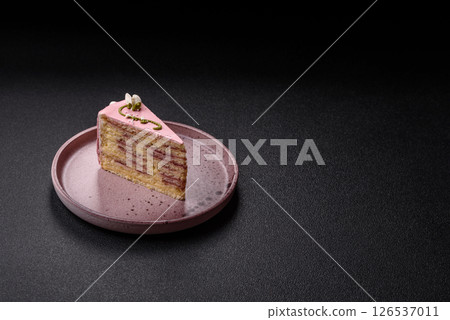 A piece of pink layered cake with strawberry flavor A piece of pink layered cake with strawberry flavor 126537011