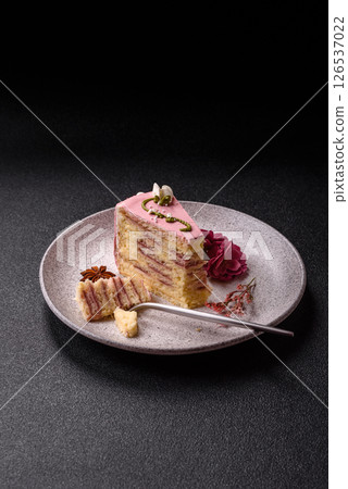 A piece of pink layered cake with strawberry flavor A piece of pink layered cake with strawberry flavor 126537022