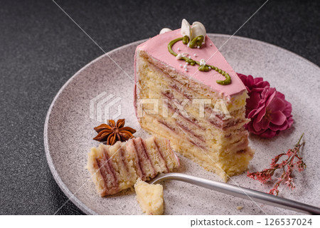 A piece of pink layered cake with strawberry flavor 126537024