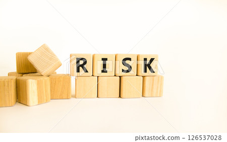 Risk symbol. Concept word Risk on beautiful wooden blocks. Beautiful white table white background. Business, lifestyle, support and risk concept. Copy space. 126537028