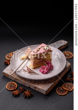 A piece of pink layered cake with strawberry flavor A piece of pink layered cake with strawberry flavor 126537042