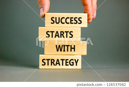 Success starts with strategy symbol. Concept words Success starts with strategy on beautiful wooden blocks. Beautiful grey background. Business and success starts with strategy concept. Copy space. 126537082