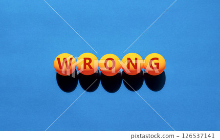 Wrong symbol. Concept word Wrong on beautiful yellow tennis ping pong balls. Beautiful wooden table wooden background. Business lifestyle wrong concept. Copy space. 126537141
