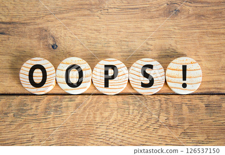 Oops symbol. Concept word Oops on beautiful wooden circles. Beautiful wooden table wooden background. Business lifestyle oops concept. Copy space. Oops symbol. Concept word Oops on beautiful wooden circles. Beautiful wooden table wooden background. Business lifestyle oops concept. Copy space. 126537150