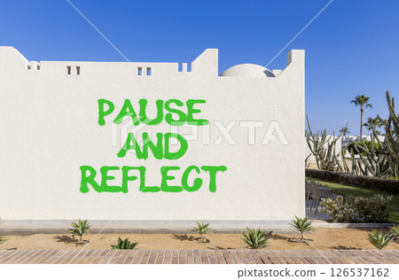 Pause and reflect symbol. Concept words Pause and reflect on beautiful white wall. Beautiful white wall blue sky background. Business motivational lifestyle pause and reflect concept. Copy space. 126537162