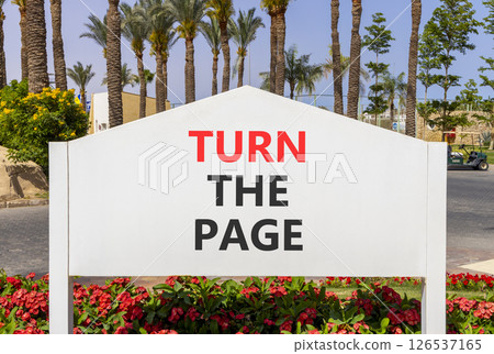 Turn the page symbol. Concept words Turn the page on beautiful big white road sign. Beautiful palm tree hotel background. Business motivational lifestyle turn the page concept. Copy space. 126537165