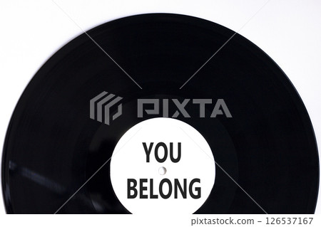 Belonging and you belong symbol. Concept words You belong on beautiful white and black vinyl disk. Beautiful white background. Business belonging and you belong concept. Copy space. Belonging and you belong symbol. Concept words You belong on beautiful white and black vinyl disk. Beautiful white background. Business belonging and you belong concept. Copy space. 126537167