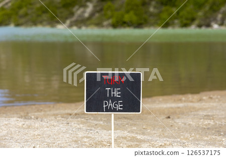 Turn the page symbol. Concept words Turn the page on beautiful blackboard. Beautiful mountain lake background. Business motivational lifestyle turn the page concept. Copy space. 126537175