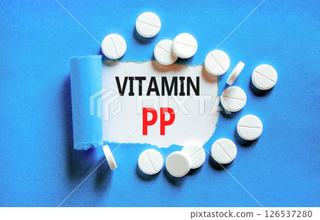 Vitamin PP symbol. Concept words Vitamin PP on beautiful white paper. White pills tablets. Beautiful blue background. Medical healthy lifestyle Vitamin PP concept. Vitamin PP symbol. Concept words Vitamin PP on beautiful white paper. White pills tablets. Beautiful blue background. Medical healthy lifestyle Vitamin PP concept. 126537280