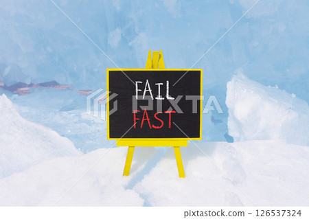 Fail fast symbol. Concept words Fail fast on beautiful yellow black blackboard. Beautiful blue ice background. Business and fail fast concept. Copy space. 126537324