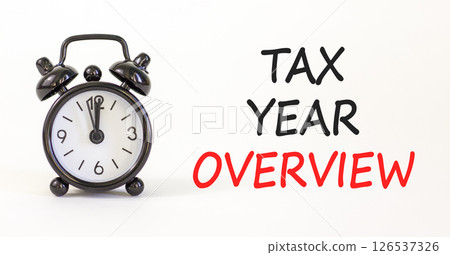 Tax year overview symbol. Concept words Tax year overview on beautiful white paper. Beautiful white background. Black alarm clock. Business tax year overview concept. Copy space. 126537326