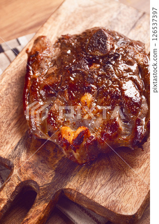 fried steak, veal neck on the bone, cooking meat, on a wooden board, top view, no people, fried steak, veal neck on the bone, cooking meat, on a wooden board, top view, no people, 126537397