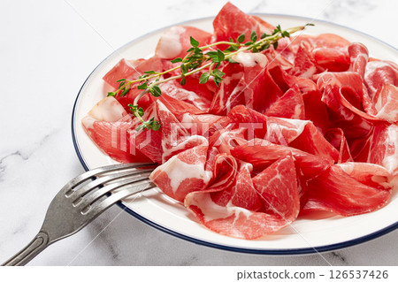 plate with sliced cured meat, pork neck, prosciutto coppa, Italian delicacy, 126537426