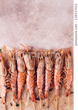shrimps on skewers, Grilled, spread on a marble surface, garnished, with lemon slices, and fresh herbs, view from above, shrimps on skewers, Grilled, spread on a marble surface, garnished, with lemon slices, and fresh herbs, view from above, 126537433