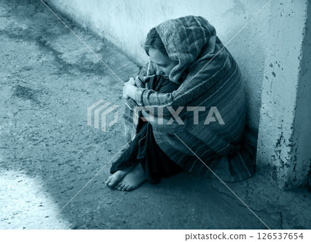Frozen girl sitting on the floor 126537654