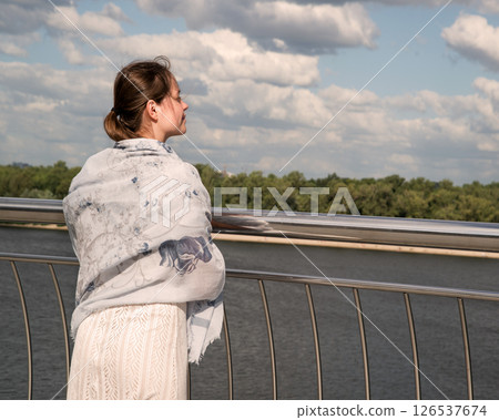 Young girl looking to the sky 126537674