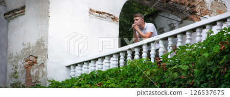 The young man stands and thinks. 126537675