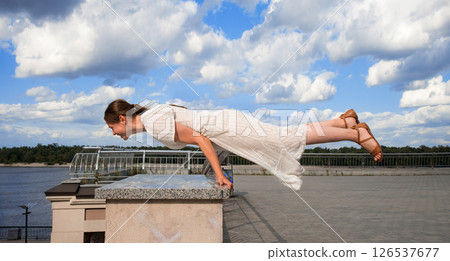 Girl in the city did a horizontal handstand 126537677