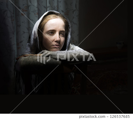 Lone sad pretty girl in dark room 126537685