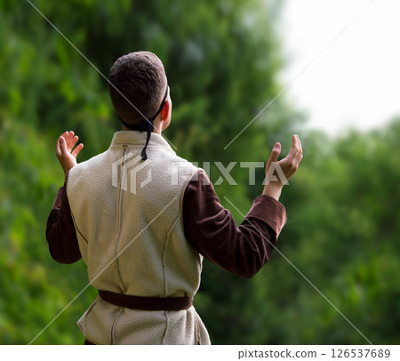 Praying man with raised hands Praying man with raised hands 126537689
