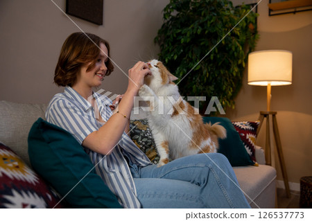 A Joyful and Heartwarming Interaction Between a Person and Their Beloved Pet Cat at Home A Joyful and Heartwarming Interaction Between a Person and Their Beloved Pet Cat at Home 126537773