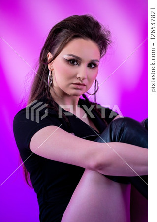 An Artistic and Stylish Portrait of a Young Woman Set Against a Striking Purple Background An Artistic and Stylish Portrait of a Young Woman Set Against a Striking Purple Background 126537821