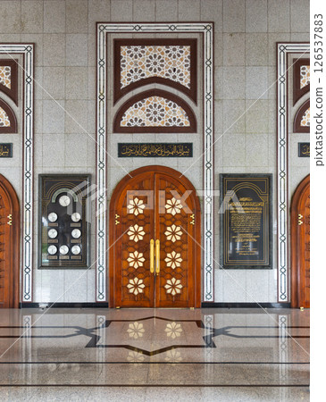 The entrance of Jame' Asr Hassanil Bolkiah Mosque, in Brunei, features ornate wooden doors and stunning geometric patterns The entrance of Jame' Asr Hassanil Bolkiah Mosque, in Brunei, features ornate wooden doors and stunning geometric patterns 126537883