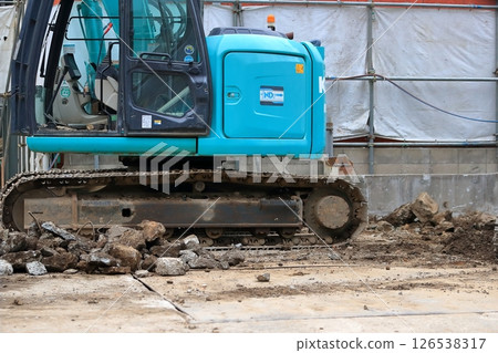 Small heavy machinery at a building demolition site 126538317
