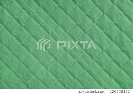 Checkered, diamond stitching pattern, green quilted fabric background. Blanket stitch texture 126538352