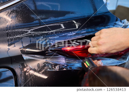 Applying a Protective Film on the Surface of Your Car for Enhanced Durability and Shine Applying a Protective Film on the Surface of Your Car for Enhanced Durability and Shine 126538413