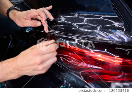 Applying a Protective Film on the Surface of Your Car for Enhanced Durability and Shine 126538416