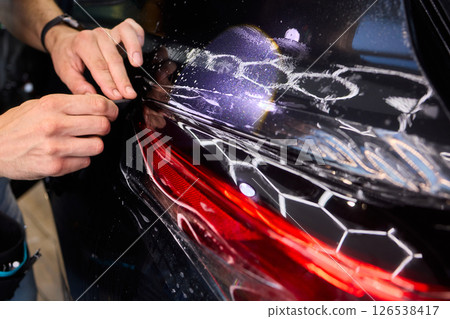 Applying a Protective Film on the Surface of Your Car for Enhanced Durability and Shine 126538417