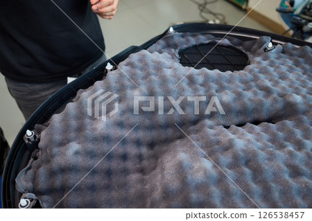 Hands Skillfully Engaged in the Construction of an Acoustic Foam Structure and Installation 126538457