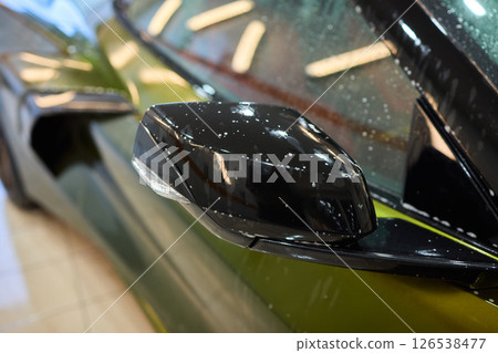 A luxury car is undergoing a foam wash treatment to enhance its appearance and shine 126538477