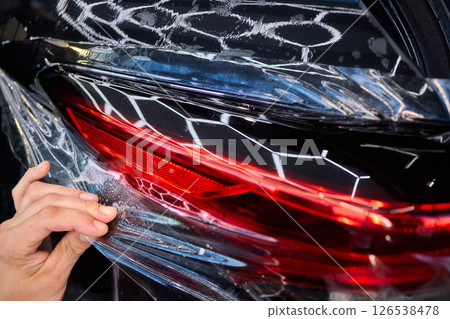 Applying a Protective Film on the Surface of Your Car for Enhanced Durability and Shine 126538478