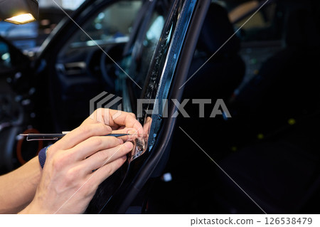 Applying a Protective Film on the Surface of Your Car for Enhanced Durability and Shine 126538479