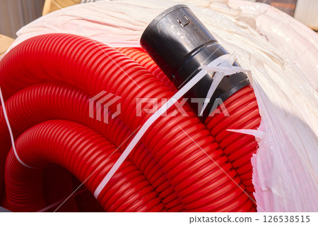 Coiled Red Hose with Connector Ideal for Various Applications Across Multiple Industries 126538515