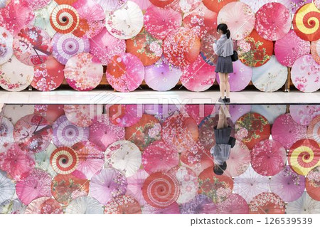 A woman and the colorful "umbrella sky" in a herb garden in Inawashiro Town, Fukushima Prefecture 126539539