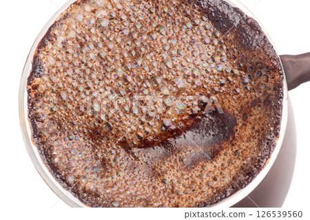 Freshly brewed ground coffee in a copper Turk isolate on a white background. 126539560