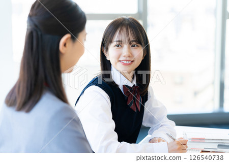 Female student and teacher studying 126540738