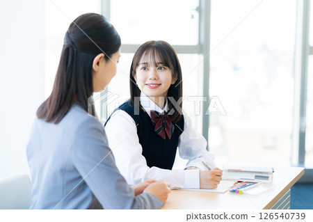 Female student and teacher studying Female student and teacher studying 126540739