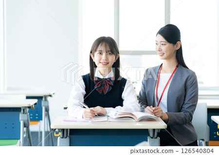 Female student and teacher studying 126540804