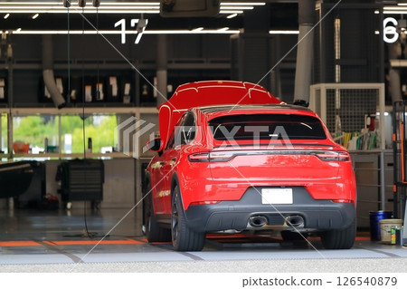 A red sports car being serviced A red sports car being serviced 126540879