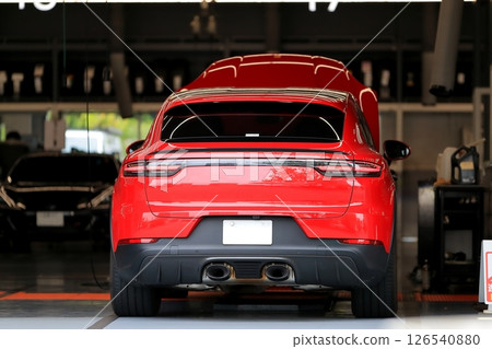 A red sports car being serviced A red sports car being serviced 126540880