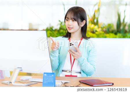 Business woman with a smartphone in the office 126543619