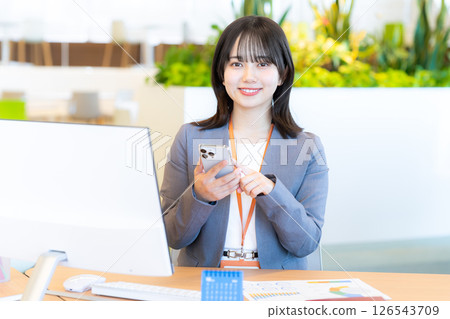 Business woman with a smartphone in the office 126543709