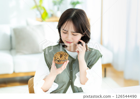 A young woman eating a snack 126544490