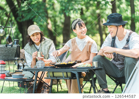 Friendly families and parents and children enjoying day camping, camping and barbecues at parks and campsites Friendly families and parents and children enjoying day camping, camping and barbecues at parks and campsites 126544587