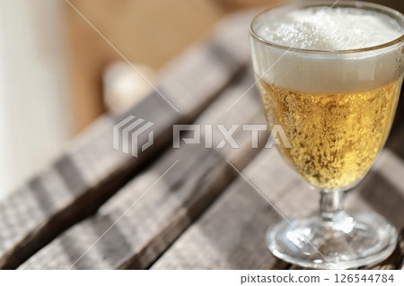 Cold beer in a goblet glass for drinking at home 126544784