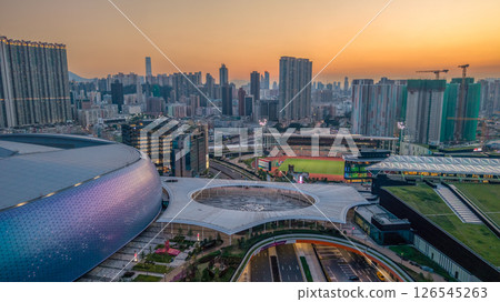 May 12 2025 Modern Urban Skyline with Stadium and Vibrant Sunset Glow 126545263